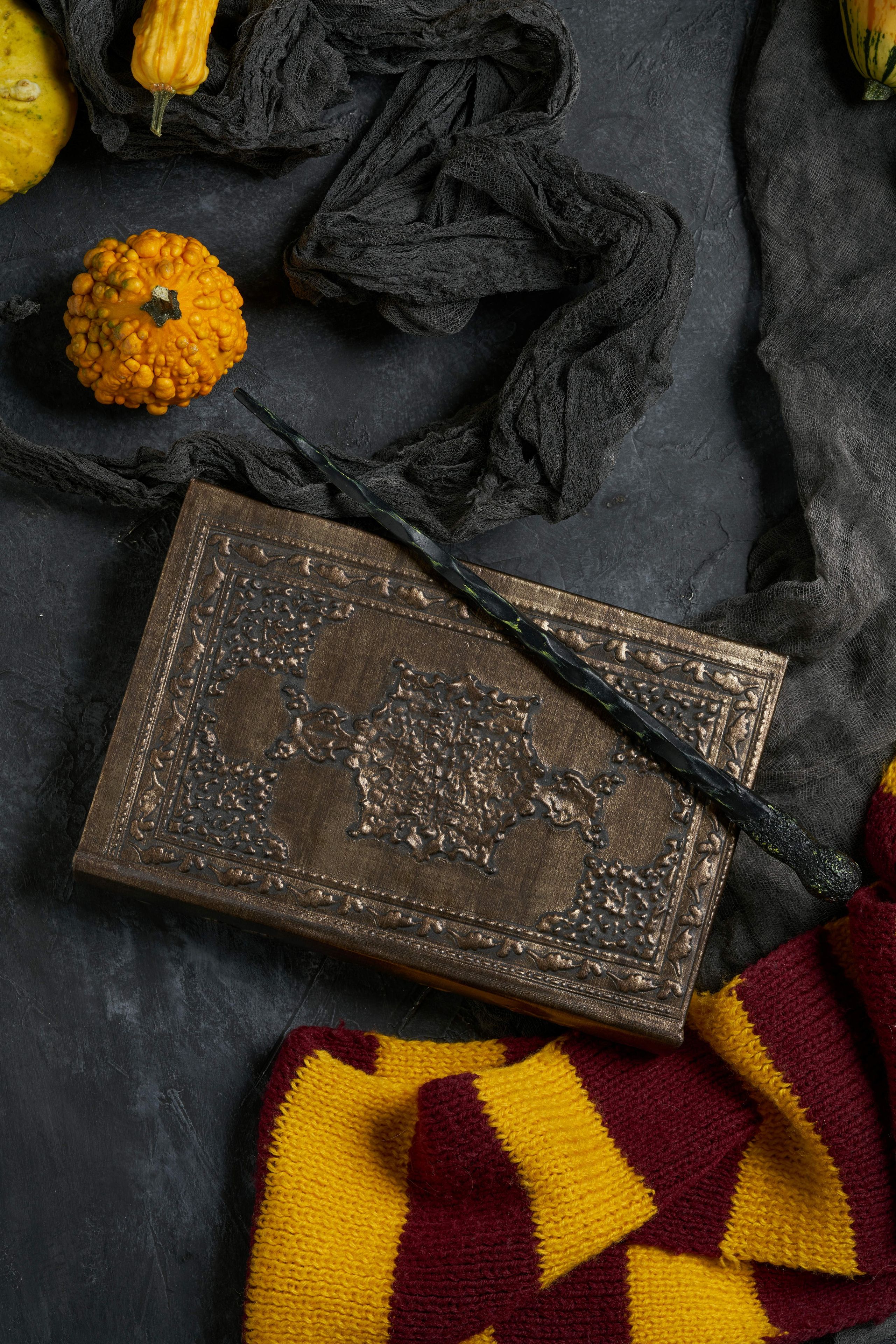 wizard spell book, wand, scarf and pumpkin