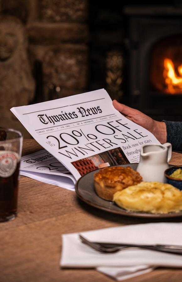 "up to 20% off this winter" newspaper with pie and a pint on a pub table